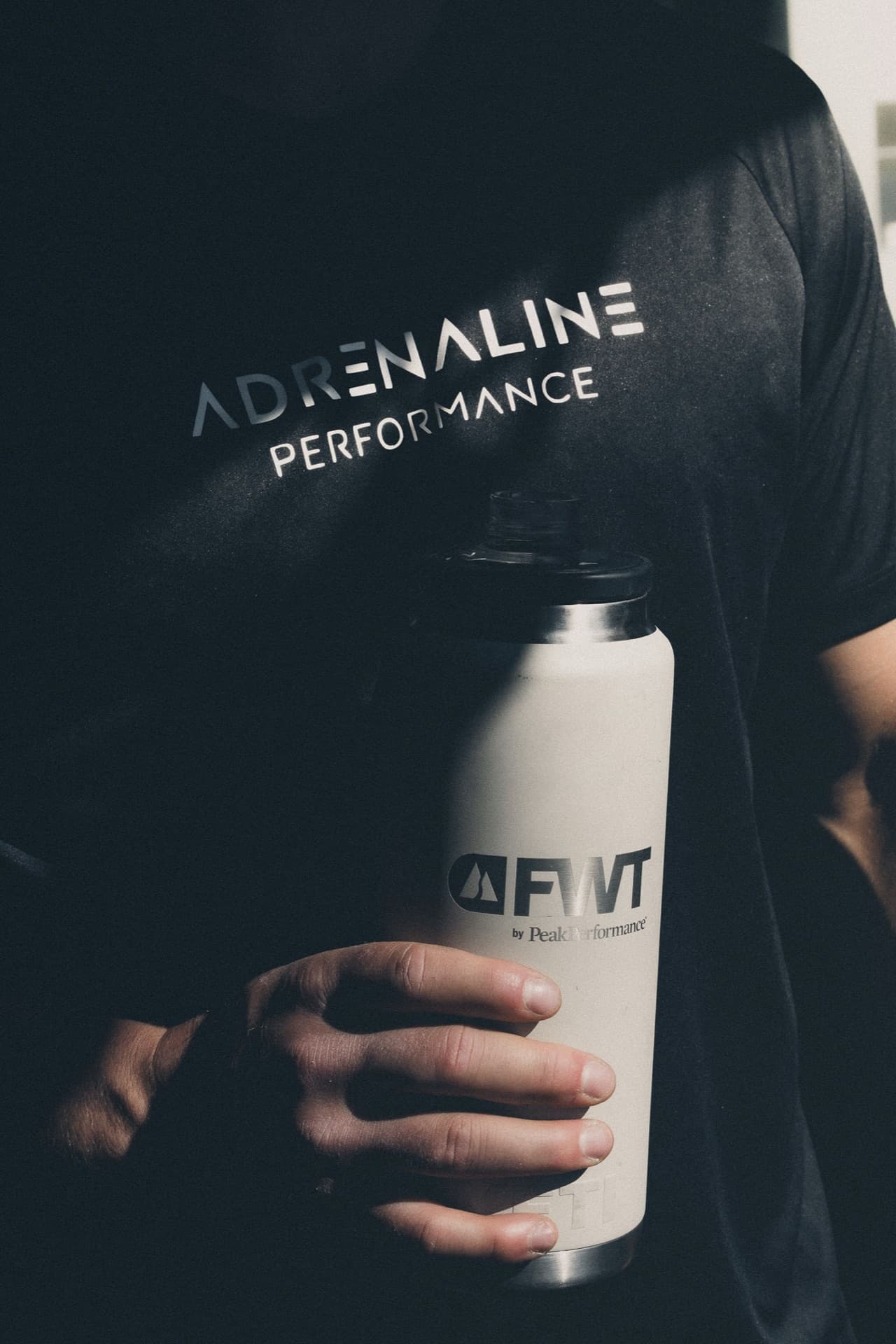 An Adrenaline Performance shirt and a water bottle, close up