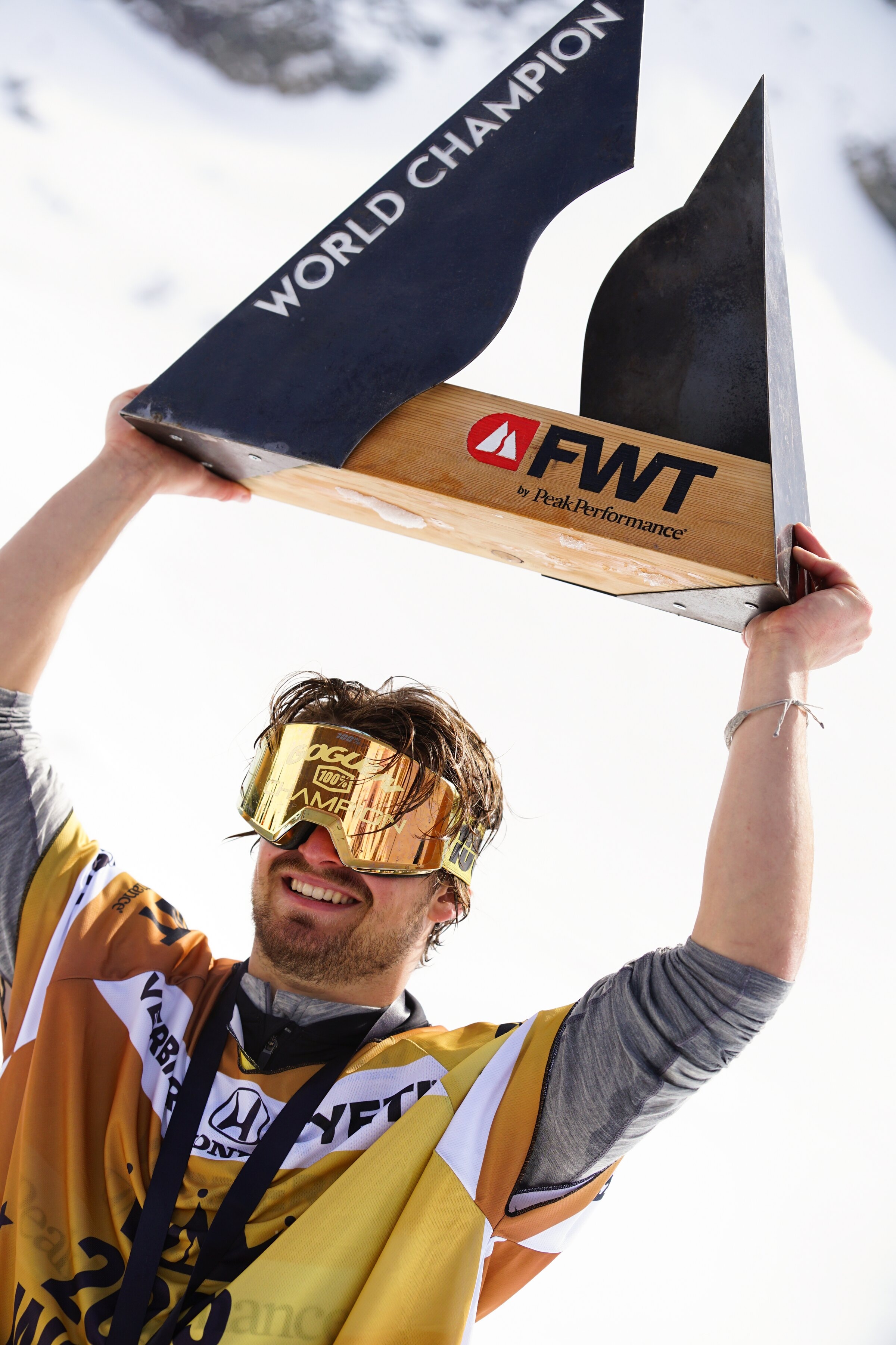 Marcus Goguen holding the Freeride World Tour world champion trophy over his head
